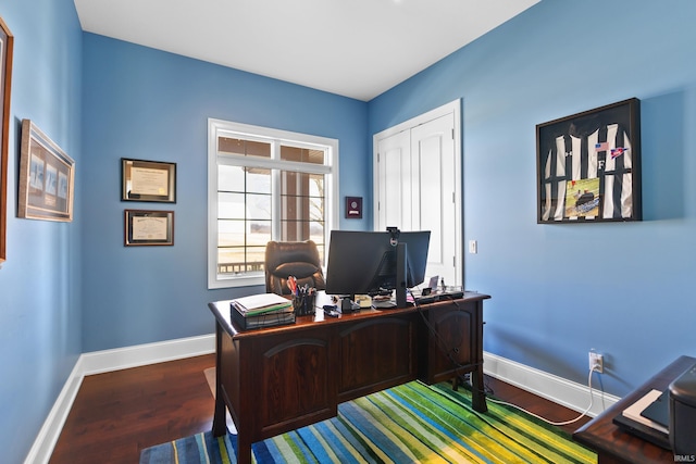 office space featuring baseboards and wood finished floors