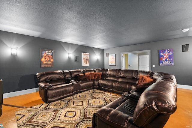 cinema featuring a textured ceiling and baseboards