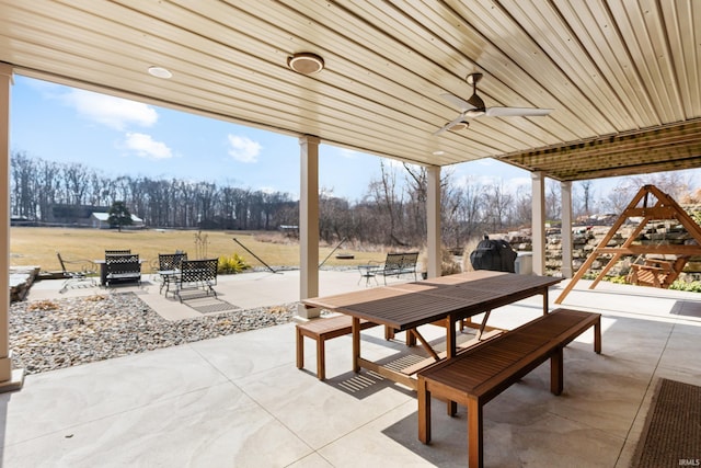 view of patio featuring a ceiling fan and outdoor dining area