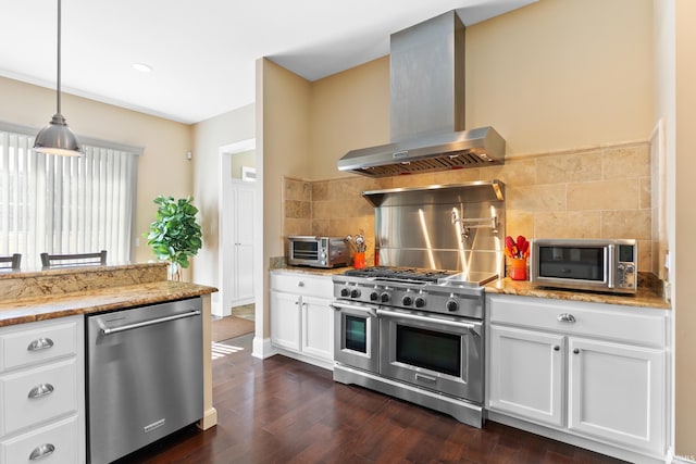 kitchen featuring a toaster, dark wood-style floors, wall chimney exhaust hood, stainless steel appliances, and backsplash