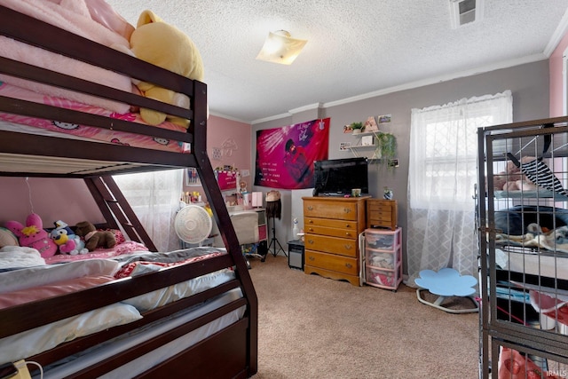 bedroom featuring a textured ceiling, carpet floors, ornamental molding, and visible vents