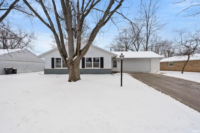 view of front of property with an attached garage, driveway, and brick siding