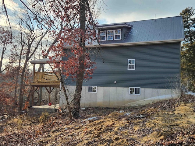 view of side of property featuring metal roof