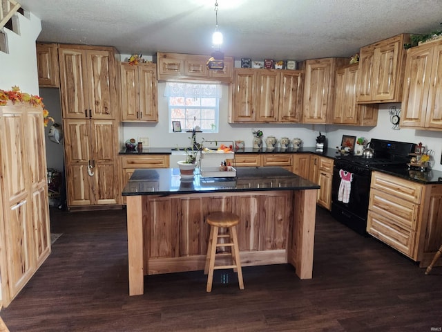 kitchen featuring black range with gas cooktop, a textured ceiling, and dark wood-type flooring