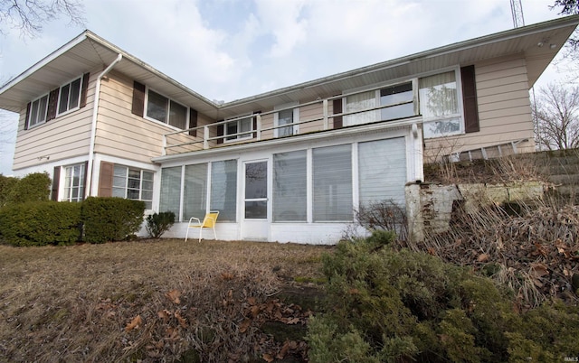 back of property featuring a balcony