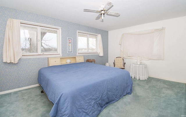 carpeted bedroom with a ceiling fan, baseboards, and wallpapered walls