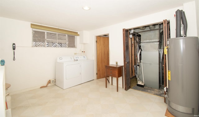 laundry room featuring laundry area, washer and clothes dryer, gas water heater, and light floors