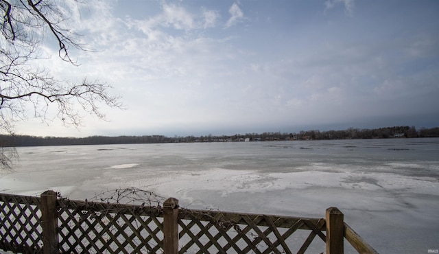 view of yard featuring a water view and fence