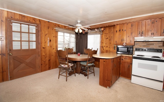 kitchen featuring light carpet, brown cabinets, under cabinet range hood, and white electric range oven