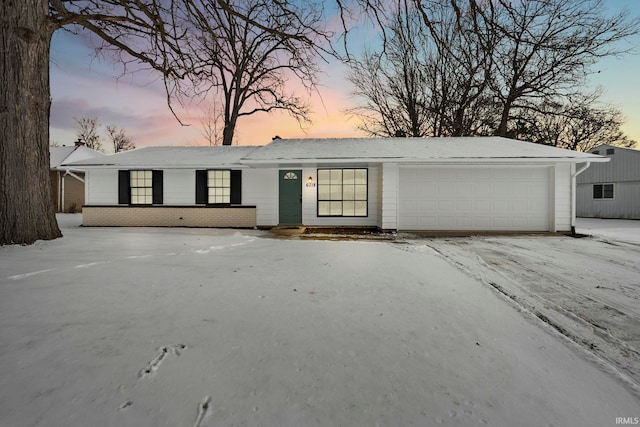 ranch-style home with brick siding and an attached garage