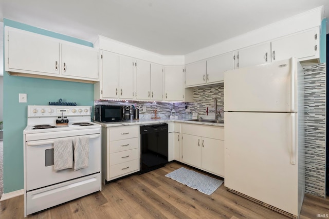 kitchen with white cabinets, black appliances, light countertops, and a sink