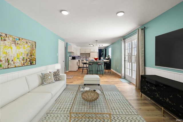 living room featuring light wood-style floors and baseboards