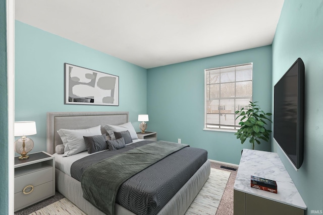 bedroom with visible vents and light colored carpet