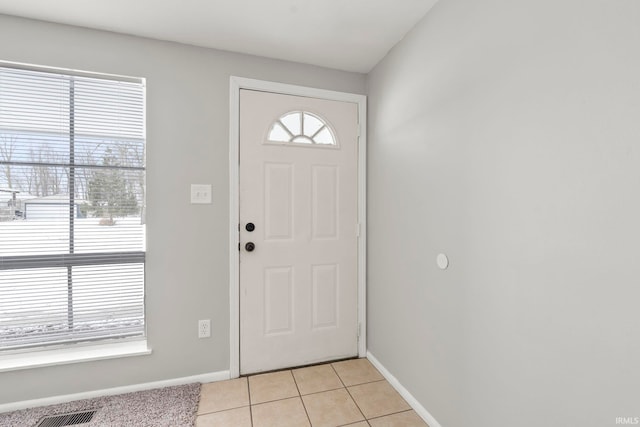 entryway featuring visible vents, baseboards, and light tile patterned floors