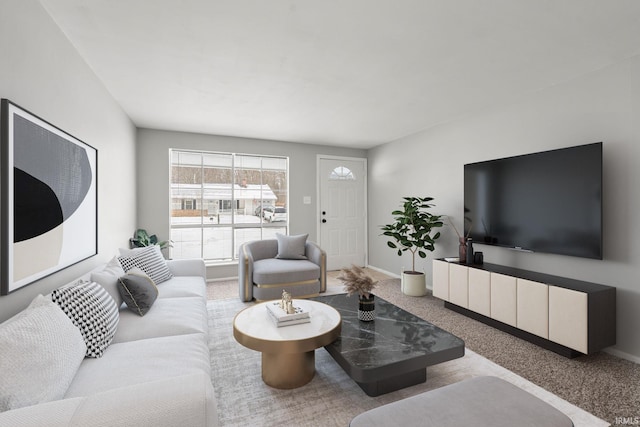 living room featuring carpet floors and baseboards