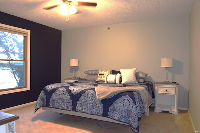 carpeted bedroom with multiple windows, baseboards, and a textured ceiling