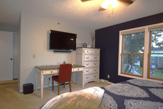 bedroom featuring a textured ceiling, baseboards, and light colored carpet