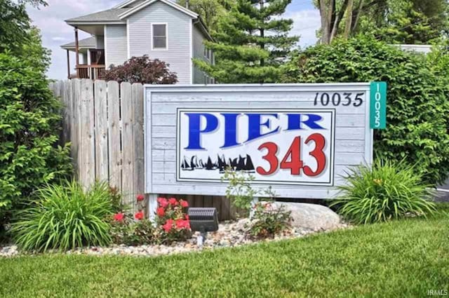 community / neighborhood sign with fence