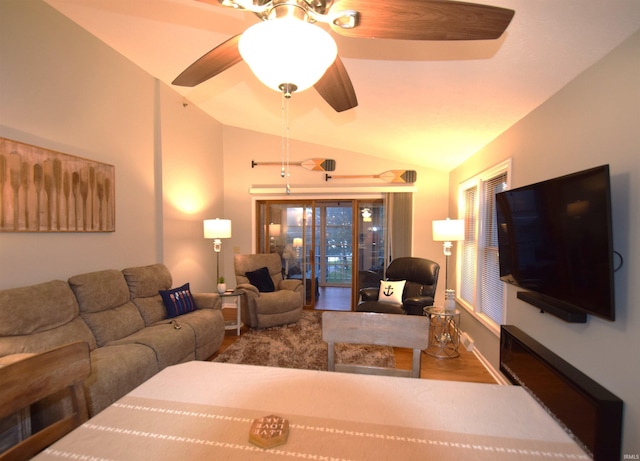 living room with vaulted ceiling, a ceiling fan, and wood finished floors