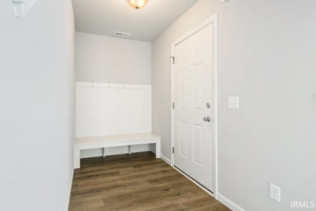 mudroom featuring wood finished floors, visible vents, and baseboards