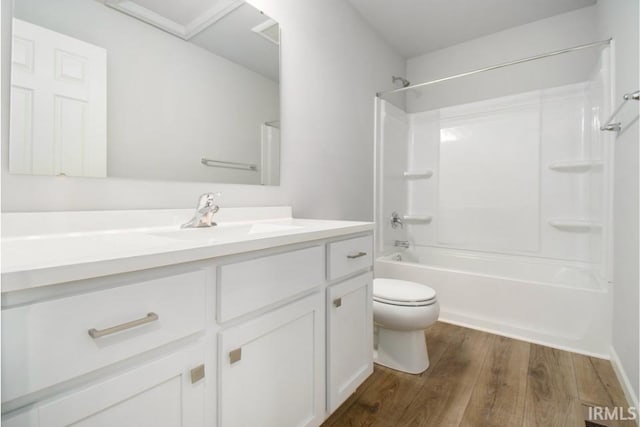 bathroom featuring shower / bathtub combination, vanity, wood finished floors, and toilet