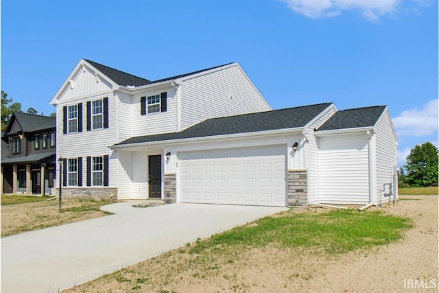 view of front of house with a garage, stone siding, board and batten siding, and concrete driveway