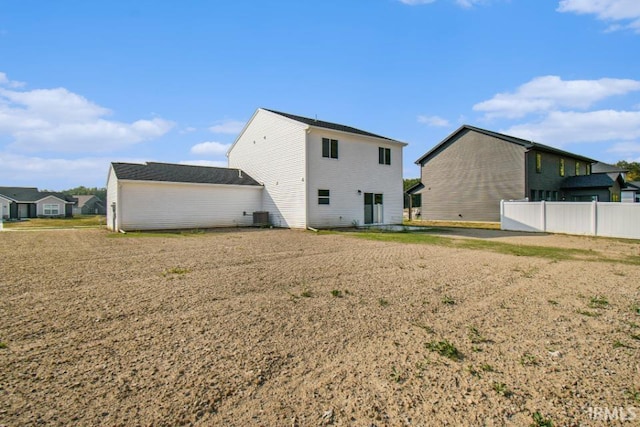 rear view of property with central AC and fence