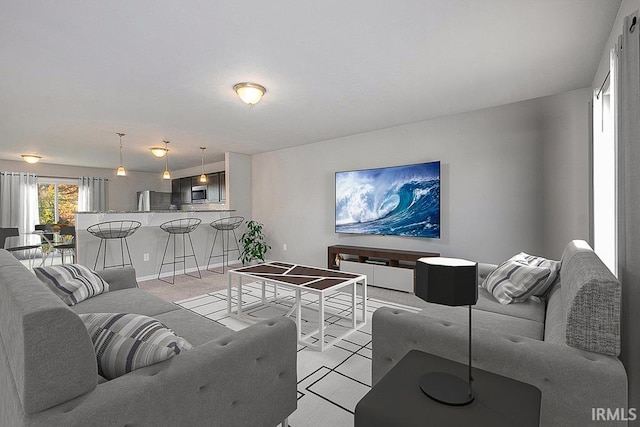 living area with baseboards and light colored carpet