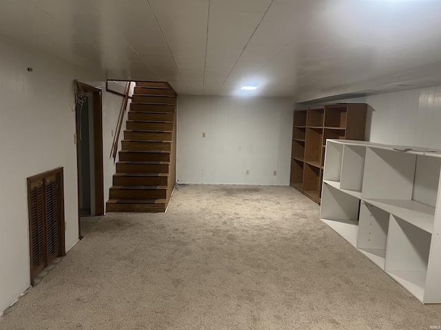 finished below grade area with carpet floors, visible vents, and stairway