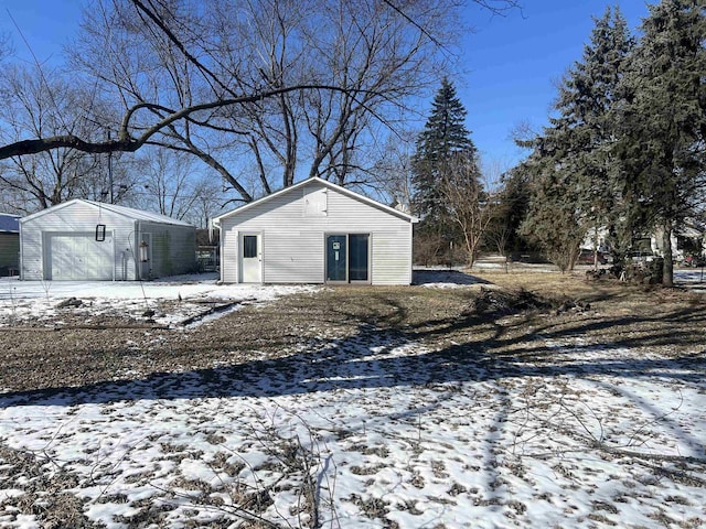 snow covered structure with an outdoor structure