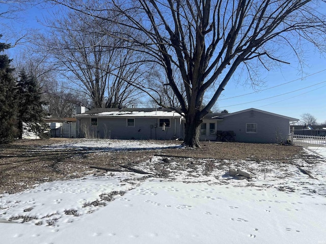 view of front of property featuring fence and a carport