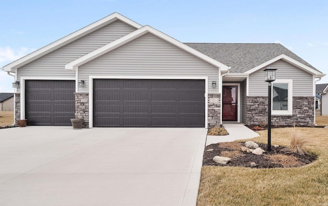 ranch-style home with a garage, concrete driveway, roof with shingles, and stone siding