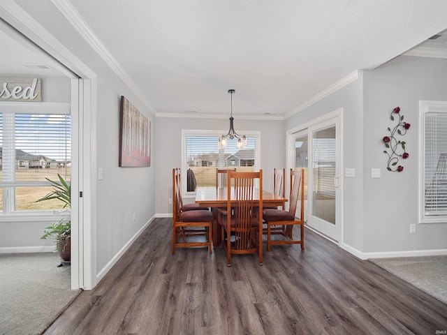 dining space featuring ornamental molding, dark wood-style flooring, and baseboards