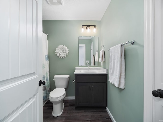 full bath featuring toilet, wood finished floors, visible vents, vanity, and baseboards