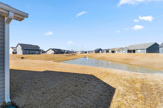 view of yard with a water view and a residential view