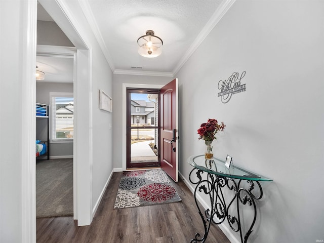 foyer with ornamental molding, wood finished floors, and baseboards