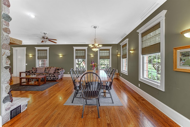 dining area featuring ornamental molding, wood finished floors, and baseboards