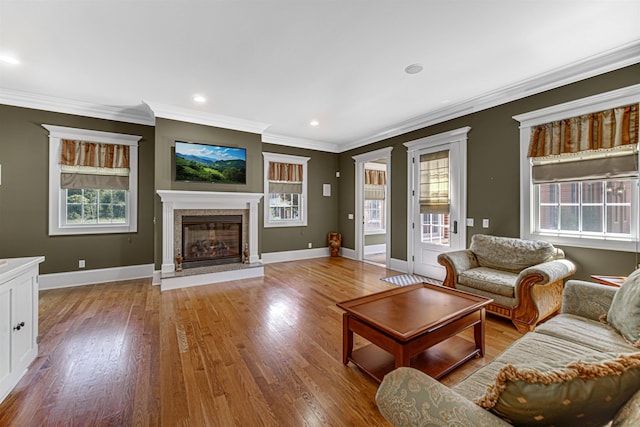 unfurnished living room with baseboards, wood finished floors, and a high end fireplace