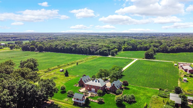 bird's eye view featuring a wooded view and a rural view