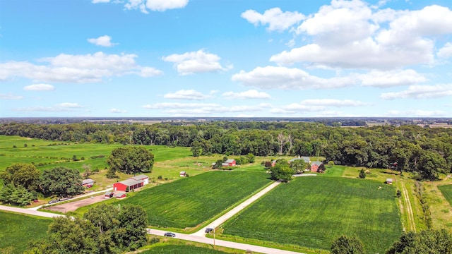 aerial view featuring a wooded view and a rural view