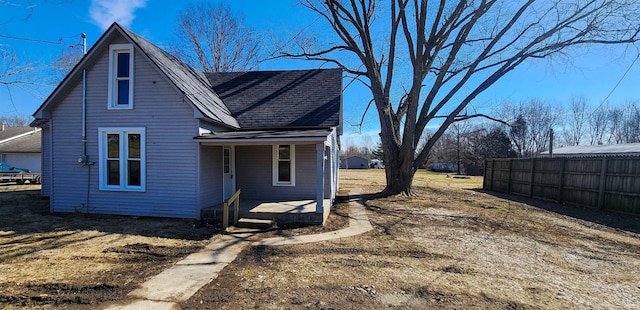 view of home's exterior featuring a porch and a shingled roof