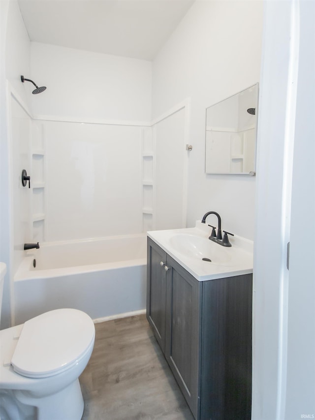 bathroom featuring vanity, shower / bath combination, wood finished floors, and toilet