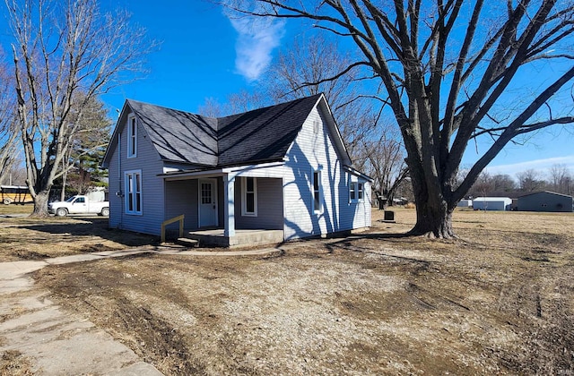 view of front of home with covered porch and roof with shingles