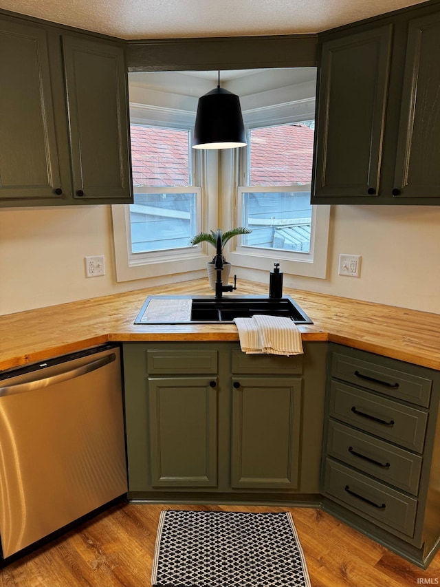 kitchen with dishwasher, butcher block counters, a sink, and light wood-style floors