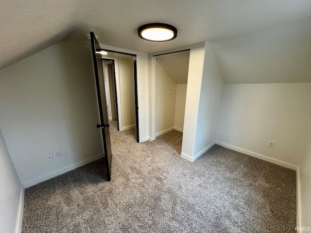 bonus room featuring carpet, baseboards, vaulted ceiling, and a textured ceiling