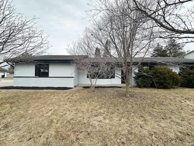 view of side of property with a yard and a chimney