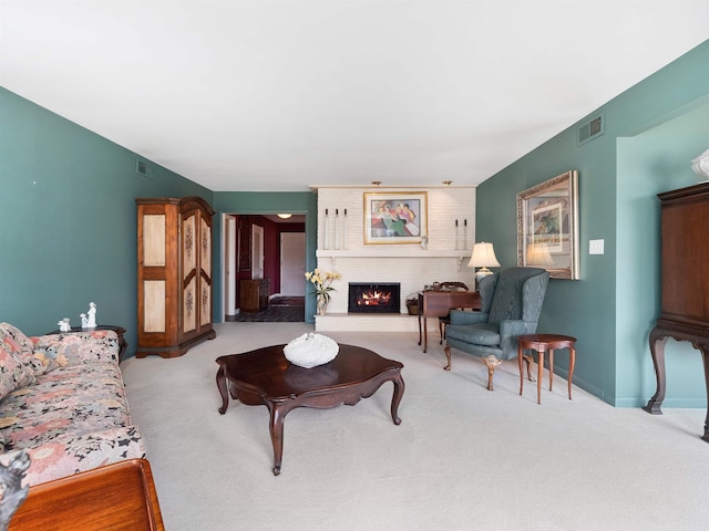 carpeted living room with baseboards, a fireplace, and visible vents