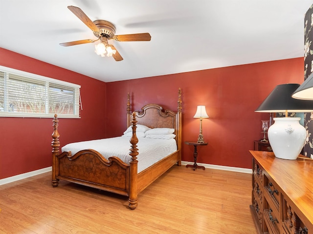 bedroom with baseboards, ceiling fan, and light wood-style floors