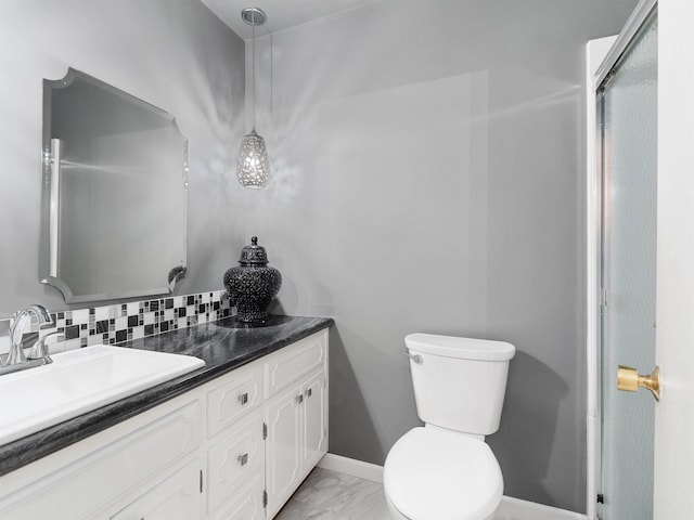 full bath featuring baseboards, decorative backsplash, toilet, marble finish floor, and vanity