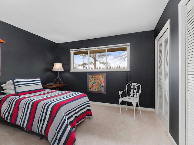 bedroom featuring carpet and baseboards